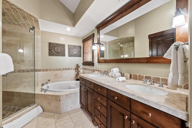 bathroom with double vanity, a stall shower, a sink, tile patterned floors, and a bath