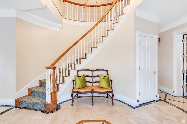 staircase featuring baseboards and ornamental molding