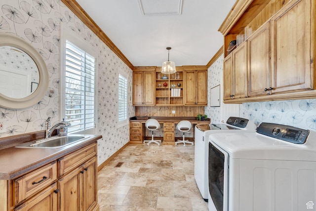 laundry room featuring wallpapered walls, a sink, cabinet space, and washing machine and clothes dryer