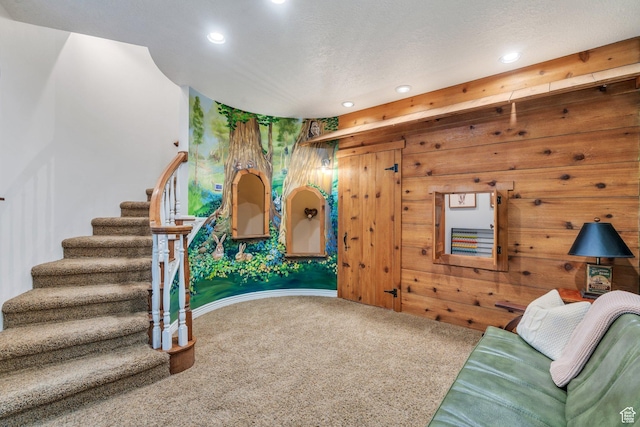 living area featuring stairway, recessed lighting, a textured ceiling, and carpet floors