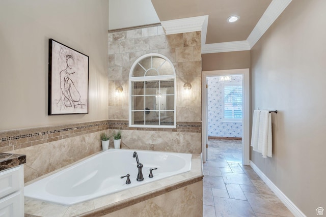 full bath with baseboards, stone tile floors, ornamental molding, and a bath