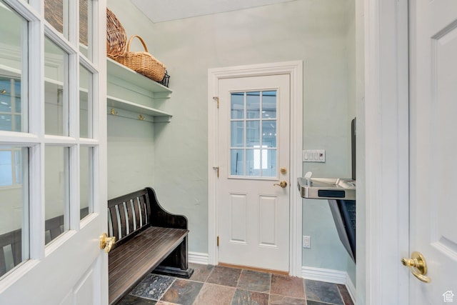 mudroom featuring baseboards and stone finish floor