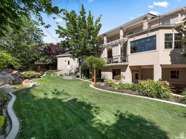 view of yard featuring a balcony