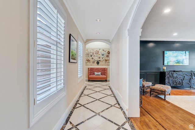 corridor with crown molding, recessed lighting, arched walkways, and baseboards