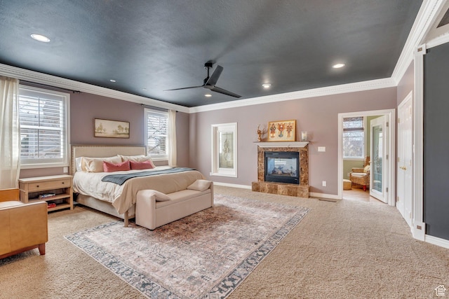 bedroom with a fireplace, crown molding, recessed lighting, and carpet