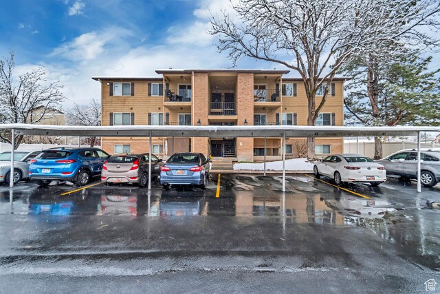 view of building exterior featuring covered parking
