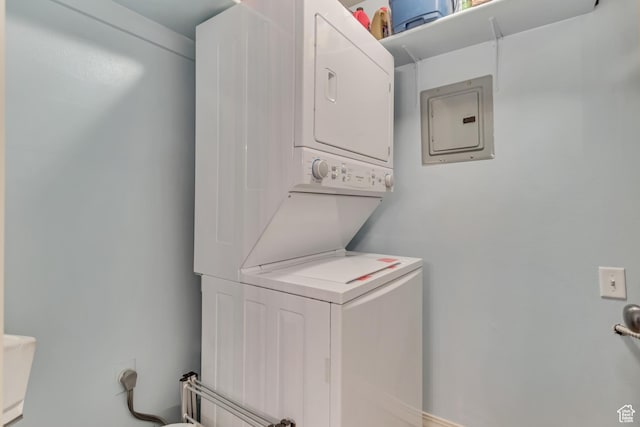 laundry area featuring stacked washer and dryer and laundry area