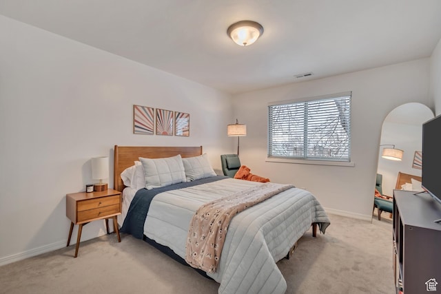 bedroom with visible vents, baseboards, and light colored carpet