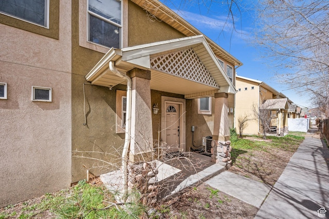 422 N Hodges Ln, Salt Lake City, UT 84116 - view of exterior entry with cooling unit and stucco siding