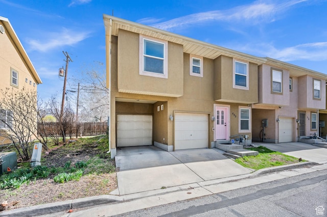 422 N Hodges Ln, Salt Lake City, UT 84116 - view of property with stucco siding, an attached garage, and concrete driveway