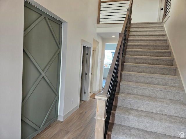 staircase with wood finished floors and baseboards