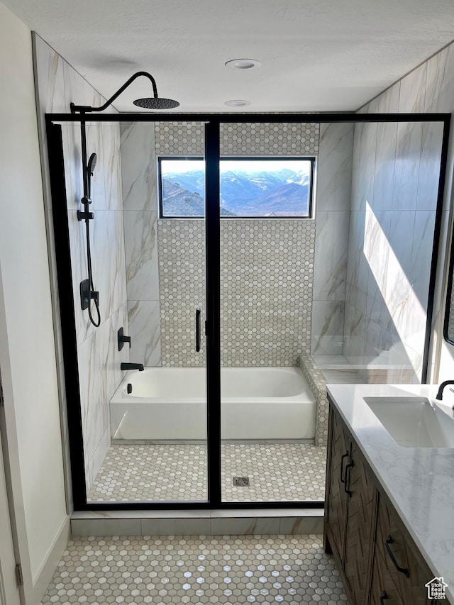 bathroom with a stall shower, vanity, and tile patterned flooring