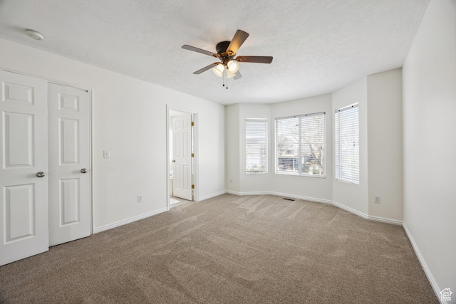 696 W 1275 N, Farmington, UT 84025 - unfurnished bedroom with carpet floors, baseboards, a textured ceiling, ceiling fan, and connected bathroom