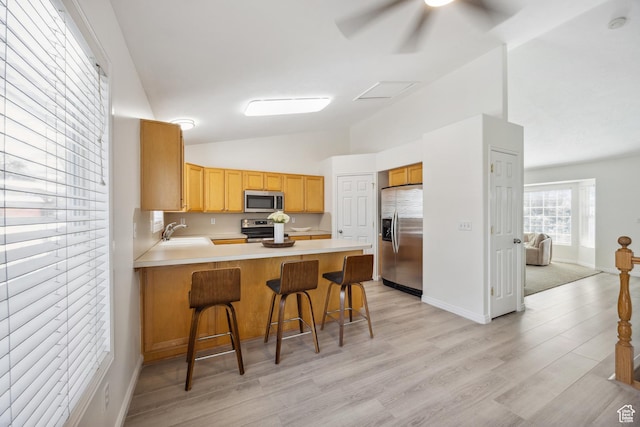 696 W 1275 N, Farmington, UT 84025 - kitchen with appliances with stainless steel finishes, a peninsula, lofted ceiling, light countertops, and ceiling fan