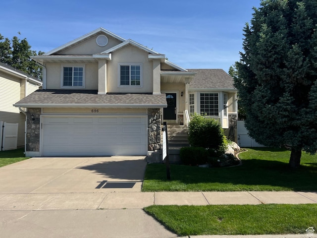 696 W 1275 N, Farmington, UT 84025 - split level home featuring stone siding, driveway, an attached garage, a front lawn, and stucco siding