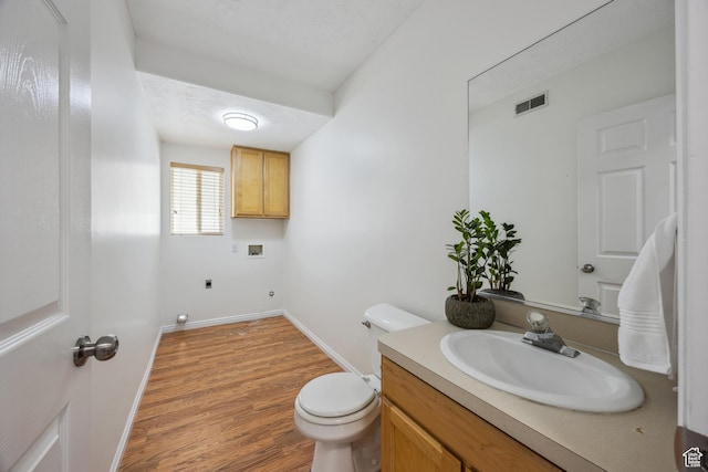 696 W 1275 N, Farmington, UT 84025 - half bathroom featuring vanity, toilet, wood finished floors, and baseboards
