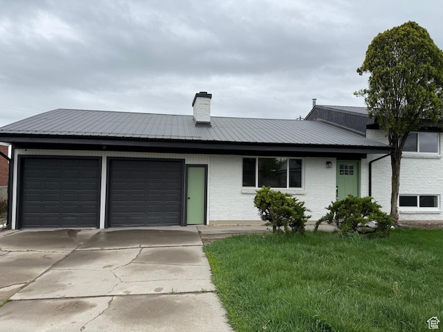 3837 W 3240 S, Salt Lake City, UT 84120 - ranch-style house with a front lawn, metal roof, a chimney, concrete driveway, and an attached garage