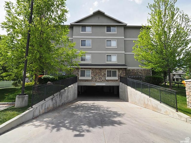 1230 E Privet Dr Unit 214, Salt Lake City, UT 84121 - multi unit property featuring stucco siding, fence, stone siding, and driveway