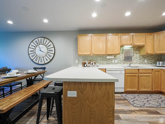 1230 E Privet Dr Unit 214, Salt Lake City, UT 84121 - kitchen featuring white dishwasher, a kitchen breakfast bar, a sink, decorative backsplash, and recessed lighting
