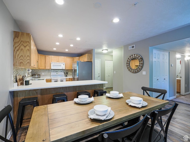 1230 E Privet Dr Unit 214, Salt Lake City, UT 84121 - dining room featuring wood finished floors, recessed lighting, and baseboards