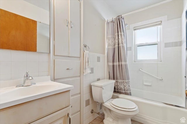 full bathroom with vanity, tile walls, shower / bath combo, and toilet