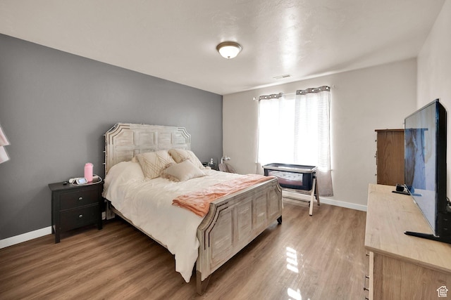 8813 S Bornite Rd, West Jordan, UT 84081 - bedroom featuring visible vents, baseboards, and light wood-style floors