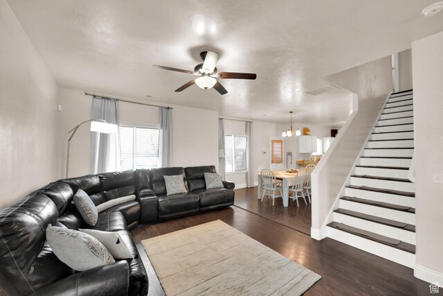 8813 S Bornite Rd, West Jordan, UT 84081 - living area featuring stairway, baseboards, wood finished floors, and ceiling fan with notable chandelier