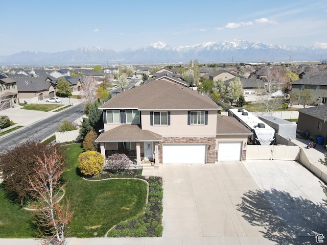 8813 S Bornite Rd, West Jordan, UT 84081 - view of front of house with a gate, fence, a residential view, driveway, and stone siding