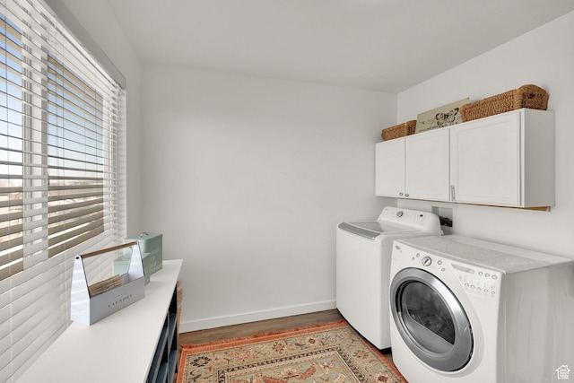 8813 S Bornite Rd, West Jordan, UT 84081 - clothes washing area featuring baseboards, wood finished floors, washer and dryer, and cabinet space