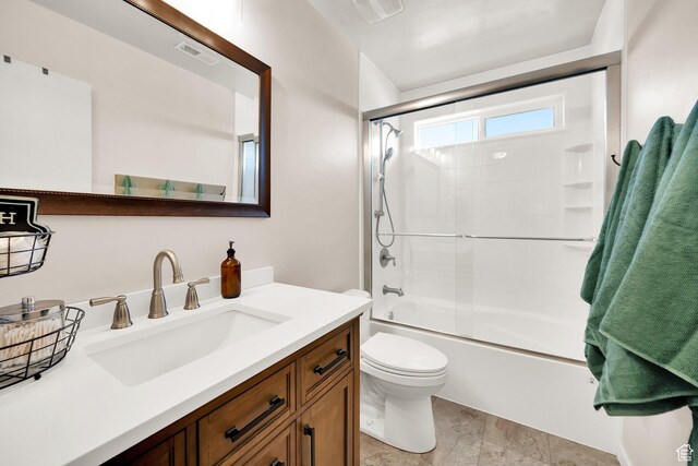 8813 S Bornite Rd, West Jordan, UT 84081 - bathroom featuring combined bath / shower with glass door, visible vents, vanity, and toilet