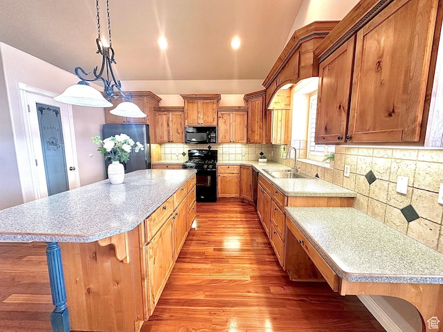 3427 N 2500 W, Farr West, UT 84404 - kitchen featuring light wood-type flooring, light countertops, brown cabinetry, black appliances, and a sink