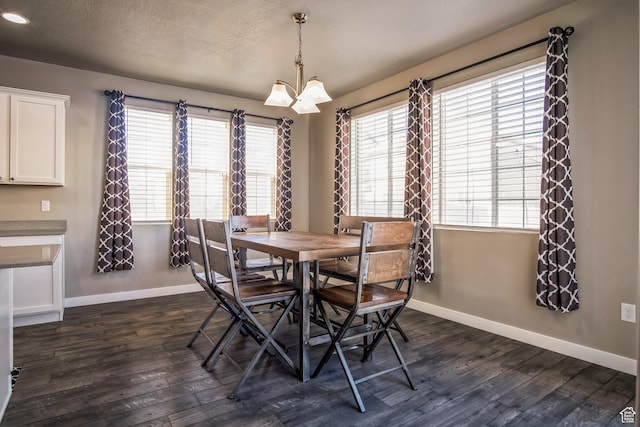 5731 W Osprey Dr, Stansbury Park, UT 84074 - dining area with baseboards, dark wood-style floors, plenty of natural light, and a textured ceiling