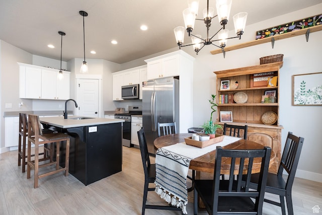 973 N Ledger Dr, Saratoga Springs, UT 84045 - dining space with a notable chandelier, recessed lighting, baseboards, and light wood-style floors