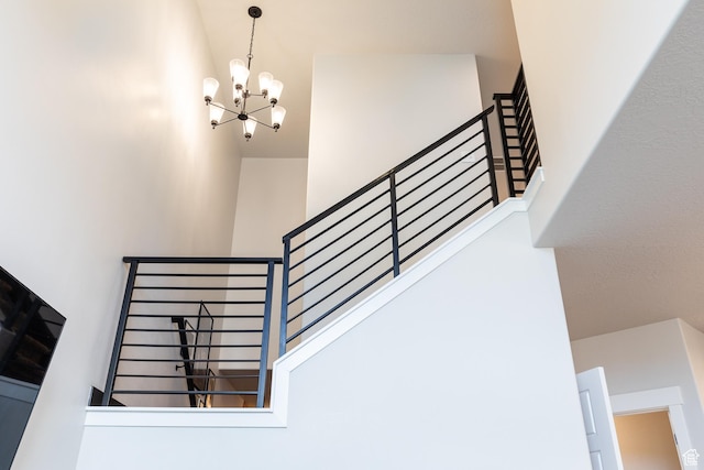 973 N Ledger Dr, Saratoga Springs, UT 84045 - stairs with a high ceiling and a notable chandelier