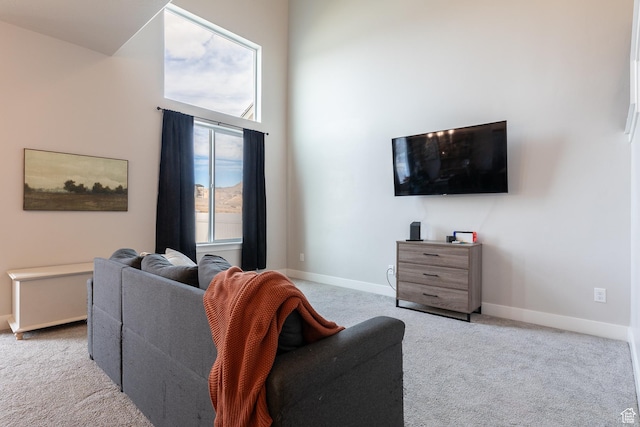 973 N Ledger Dr, Saratoga Springs, UT 84045 - living room featuring a towering ceiling, baseboards, and carpet floors