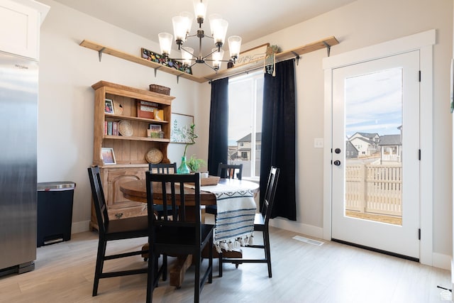 973 N Ledger Dr, Saratoga Springs, UT 84045 - dining room with visible vents, baseboards, light wood finished floors, and a chandelier