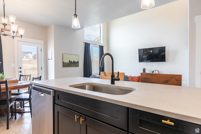 973 N Ledger Dr, Saratoga Springs, UT 84045 - kitchen featuring a sink, stainless steel dishwasher, hanging light fixtures, and light countertops