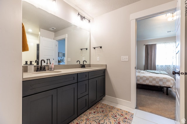 973 N Ledger Dr, Saratoga Springs, UT 84045 - ensuite bathroom featuring a sink, visible vents, ensuite bath, and tile patterned flooring