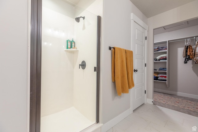 973 N Ledger Dr, Saratoga Springs, UT 84045 - full bath featuring baseboards, marble finish floor, and a stall shower