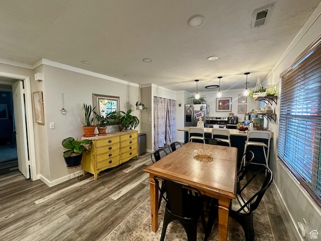 681 E Vine St S, Murray, UT 84107 - dining space featuring wood finished floors, a wealth of natural light, and ornamental molding