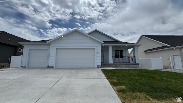 437 W 1910 N Unit 317, Tooele, UT 84074 - ranch-style house with a porch, an attached garage, concrete driveway, a front yard, and board and batten siding