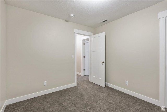 4089 W 1700 N Unit 618, Lehi, UT 84043 - empty room with dark colored carpet, visible vents, baseboards, and a textured ceiling