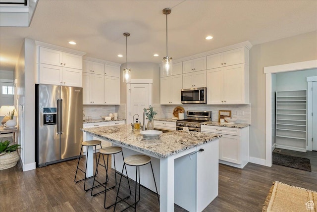 4089 W 1700 N Unit 618, Lehi, UT 84043 - kitchen with dark wood finished floors, white cabinetry, stainless steel appliances, and a kitchen bar