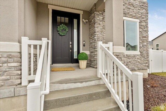 4089 W 1700 N Unit 618, Lehi, UT 84043 - property entrance with fence, stone siding, and stucco siding