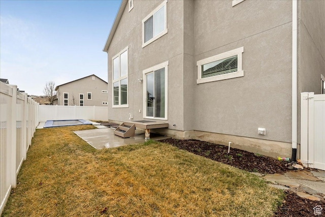 4089 W 1700 N Unit 618, Lehi, UT 84043 - rear view of house with a patio, a yard, a fenced backyard, and stucco siding