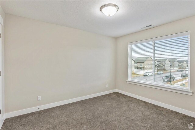 4089 W 1700 N Unit 618, Lehi, UT 84043 - empty room featuring visible vents, a textured ceiling, baseboards, and dark colored carpet