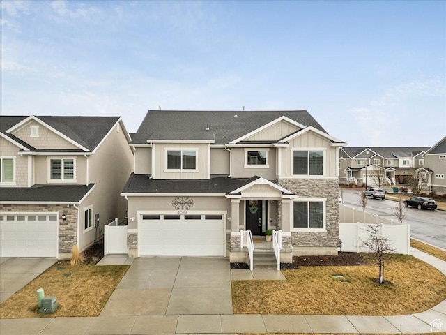 4089 W 1700 N Unit 618, Lehi, UT 84043 - view of front of home featuring board and batten siding, fence, concrete driveway, a garage, and stone siding