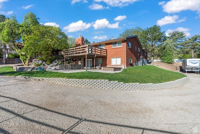 1411 E Elm Leaf Cv, Salt Lake City, UT 84117 - rear view of property featuring brick siding, stairway, a yard, a deck, and a patio
