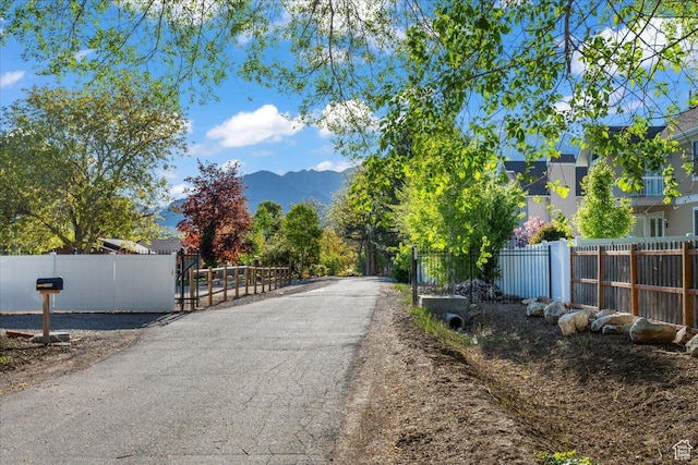 1411 E Elm Leaf Cv, Salt Lake City, UT 84117 - view of street with a mountain view and a gate