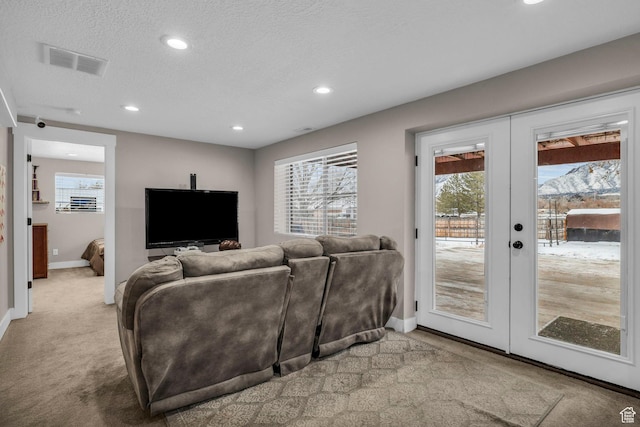 1411 E Elm Leaf Cv, Salt Lake City, UT 84117 - living area with visible vents, light colored carpet, french doors, and a healthy amount of sunlight